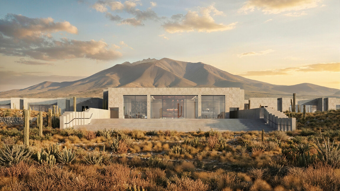 Außenansicht der Casa Gastón bei Uyuni mit moderner Architektur aus Naturstein, großen Glasfronten und Kakteen in karger Andenlandschaft vor Bergkulisse.