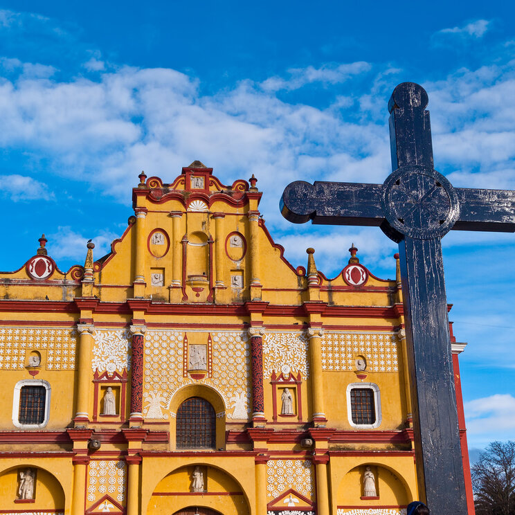 Gelbe Kathedrale in San Christóbal de las Casas mit Kreuz im Vordergrund